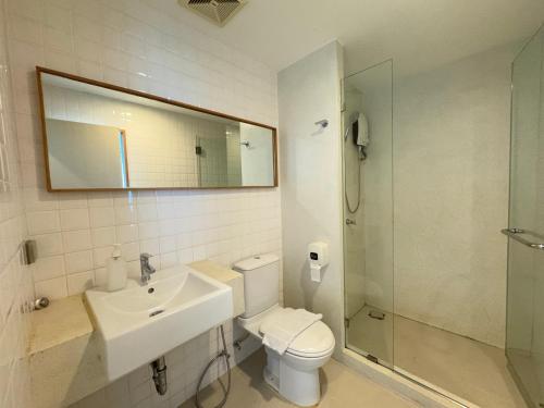a bathroom with a toilet and a sink and a shower at CHERN Bangkok in Bangkok