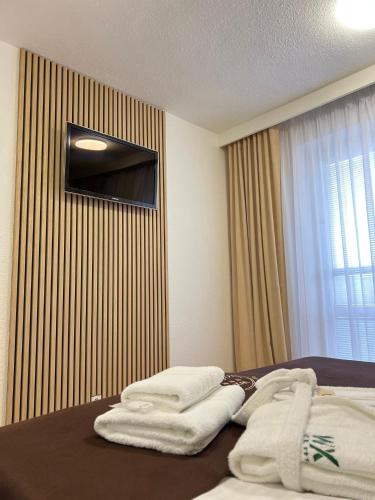 a hotel room with two towels on a bed at WX Hotel in Bratislava