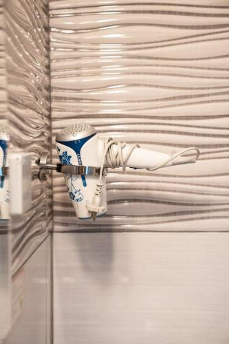 a white and blue cup hanging on a wall at Haus Kärnten in Döbriach