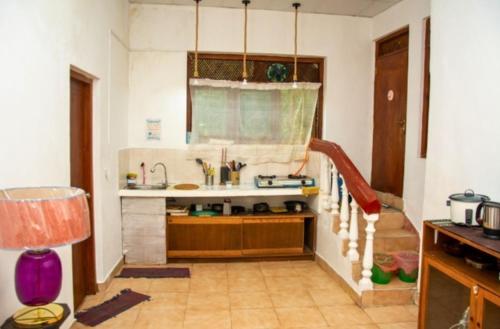 a kitchen with a sink and a counter at The Kingston Court in Kandy