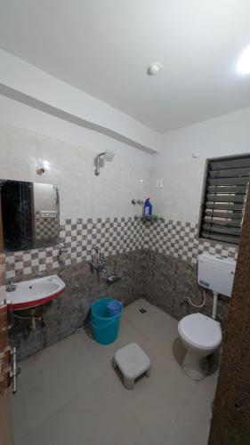 a bathroom with a toilet and a sink and a tub at Jalsa Home Stay in Sheoganj