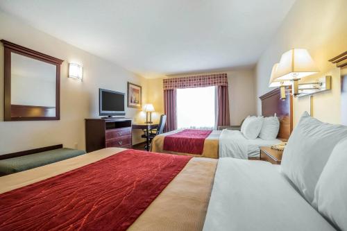 a hotel room with two beds and a television at Comfort Inn & Suites Rock Springs-Green River in Rock Springs
