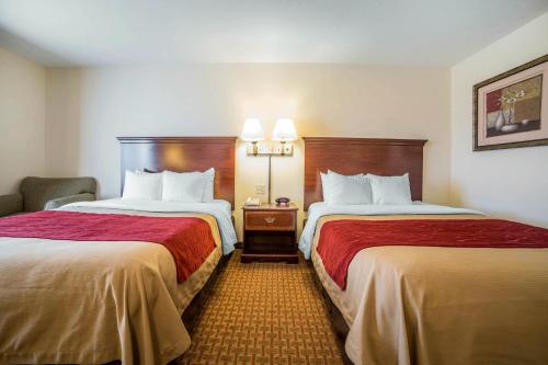 a hotel room with two beds and a chair at Comfort Inn & Suites Rock Springs-Green River in Rock Springs