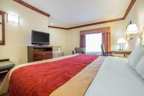 a hotel room with a large bed and a flat screen tv at Comfort Inn & Suites Rock Springs-Green River in Rock Springs