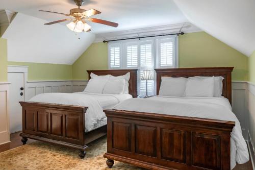 a bedroom with two beds and a ceiling fan at Inn at I'On, an Ascend Collection Hotel in Charleston