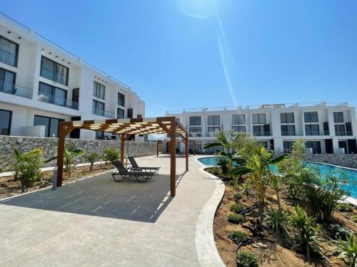a bench under a canopy in front of a building at Penthouse Blueberry in Kérynia