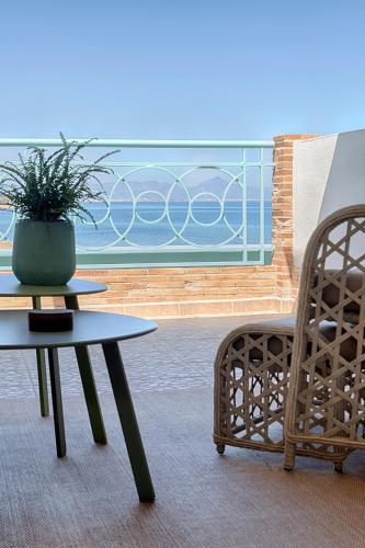 a table and a chair in a room with a window at Hotel Noguera Mar in Denia