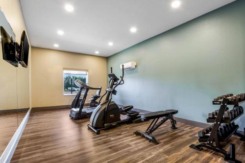 a gym with treadmills and exercise bikes in a room at MainStay Suites Winfield-Teays Valley in Hurricane