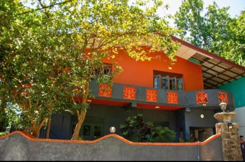 an orange building with a balcony on top of it at The Kingston Court in Kandy