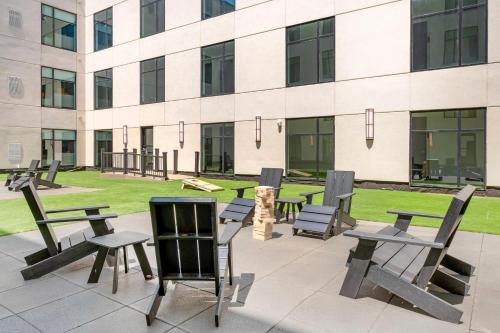 a group of tables and chairs in front of a building at Cambria Hotel Detroit Downtown in Detroit