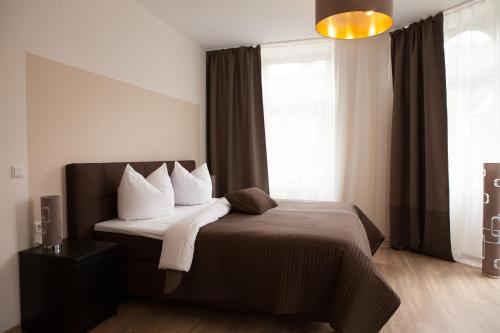 a bedroom with a bed and a large window at Hotel Ravene in Cochem