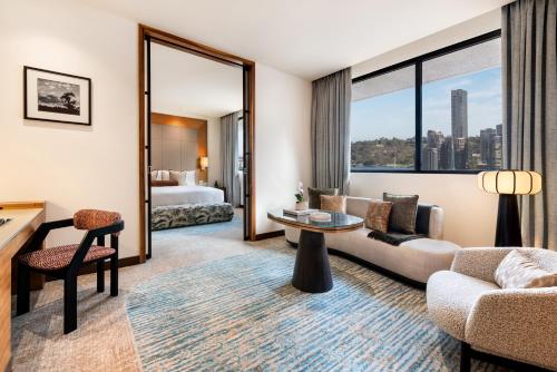 a hotel room with a couch and a table at Pan Pacific Perth in Perth