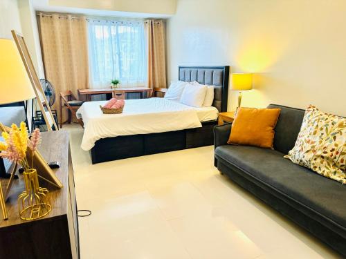 a living room with a bed and a couch at Brenthill Premium Condo Baguio City with Generator in Baguio