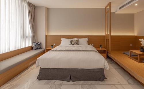 a bedroom with a large bed and a window at Sun Moon Lake Apollo Resort Hotel in Yuchi