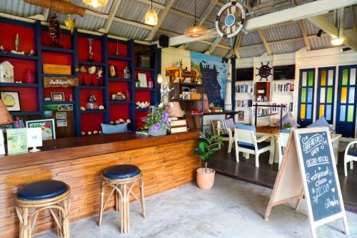 a restaurant with a counter and stools in a room at Baan Thong Ching Resort in Khanom