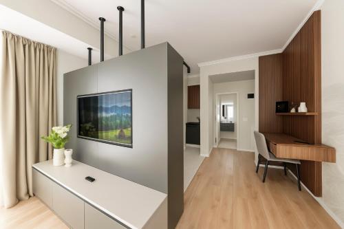 a living room with a table and a desk at ONE66 - Luxury Aparthotel in Braşov
