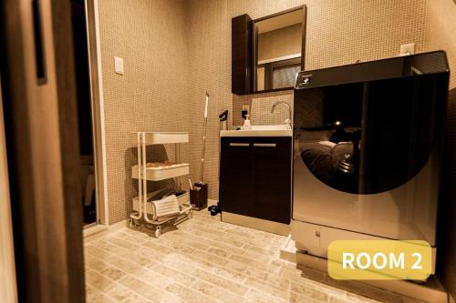 a bathroom with a tv in a room with a sink at LEO Building No25 in Funabashi