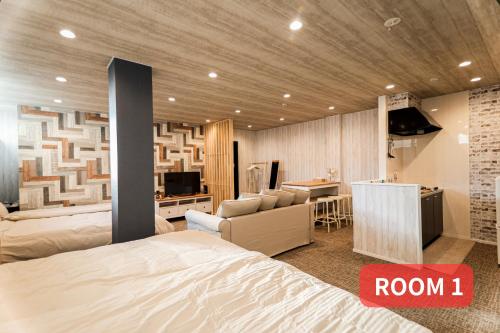 a bedroom with a bed and a living room and a kitchen at LEO Building No25 in Funabashi