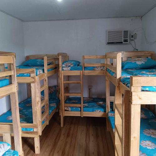 a group of bunk beds in a room at Casa Benito Resort in Sauay