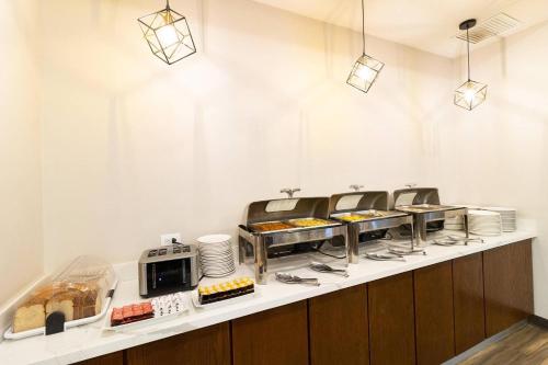 a buffet line with bread and pastries in a restaurant at Comfort Inn Ciudad Juarez in Ciudad Juárez