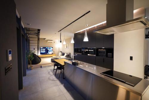 a kitchen with a counter and a table in it at amairo Villa in Asahikawa