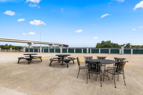 a group of tables and chairs on a patio at Econo Lodge in Belton