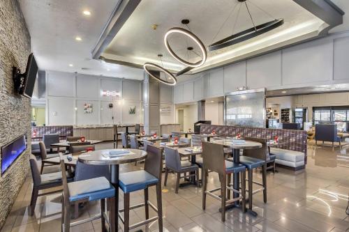 a restaurant with tables and chairs in a room at Radisson Hotel Salt Lake City Airport in Salt Lake City