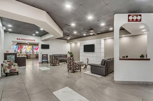 a lobby with couches and chairs in a store at Suburban Studios Salt Lake City Airport in Salt Lake City