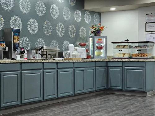 a kitchen with a counter with food on it at Suburban Studios Salt Lake City Airport in Salt Lake City