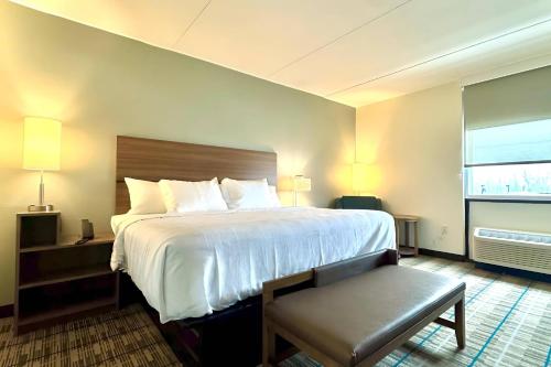 a hotel room with a large bed and a window at MainStay Suites Chambersburg in Chambersburg