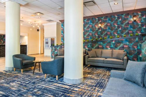 a lobby with couches and a table and chairs at Grand Park Hotel & Suites Downtown Vancouver, an Ascend Collection Hotel in Vancouver