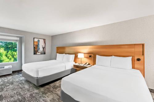 a hotel room with two beds and a window at Radisson Hotel Portland Airport in Portland