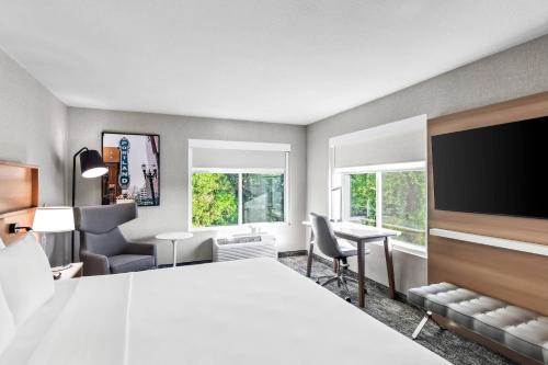 a hotel room with a large bed and a desk at Radisson Hotel Portland Airport in Portland