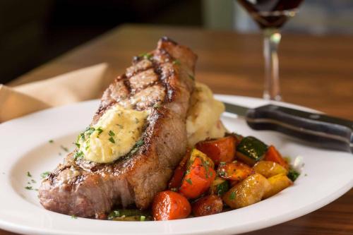 a plate of food with a piece of meat and vegetables at Radisson Hotel Portland Airport in Portland