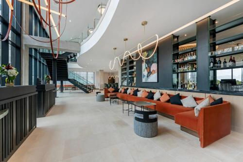 a lobby of a hotel with couches and a bar at Cambria Hotel Austin Downtown in Austin