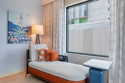 a room with a chair and a window at Cambria Hotel Austin Downtown in Austin