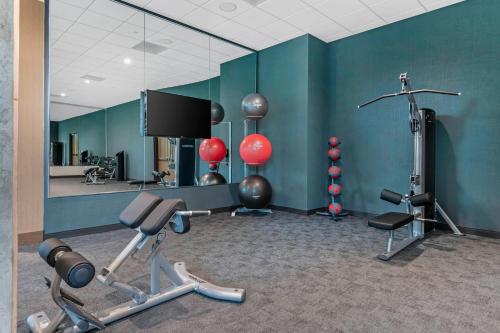 a gym with several exercise equipment in a room at Cambria Hotel Austin Downtown in Austin