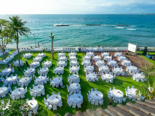 an overhead view of a group of white chairs and the ocean at Discovery Kartika Plaza Hotel in Kuta