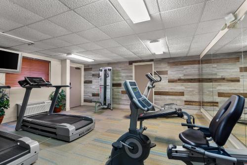 a gym with two treadmills and two exercise bikes at Suburban Studios in Altoona
