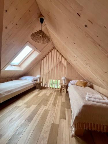 a attic bedroom with a bed and a window at Hvile, gmina Brenna - BESKIDY in Górki Wielkie