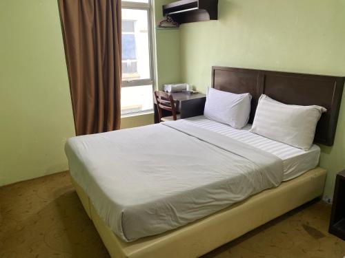 Postel nebo postele na pokoji v ubytování Five Ferns Hotel