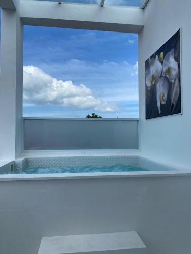 a room with a window with a painting of flowers at Klissy Studio Villa in Kerobokan