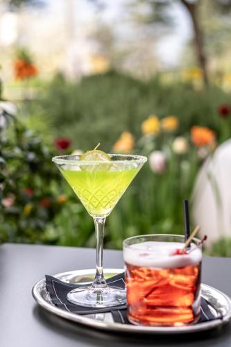 two cocktails on a tray on a table at Hotel Mignon Meran Park & Spa in Merano
