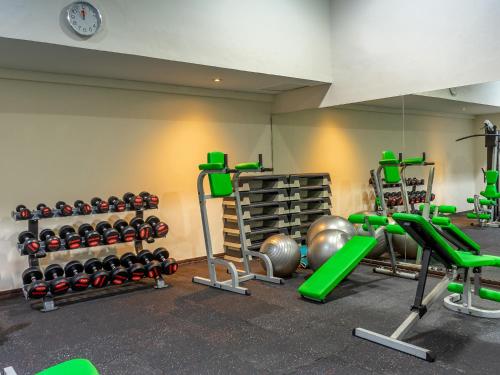 a gym with dumbbells and weights in a room at Discovery Kartika Plaza Hotel in Kuta