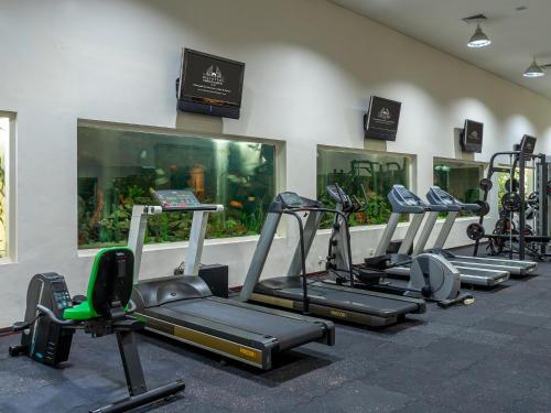 a row of treadmills and machines in a gym at Discovery Kartika Plaza Hotel in Kuta