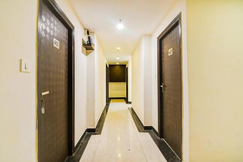 a hallway with two sets of doors and a walkway at Super Collection O City Center New Town Kolkata Formerly Paradise Inn in Salua