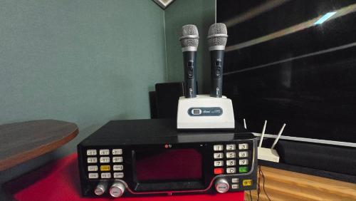 two microphones sitting on top of a electronic device at A Bridge House 1C-1 in Jung-gu