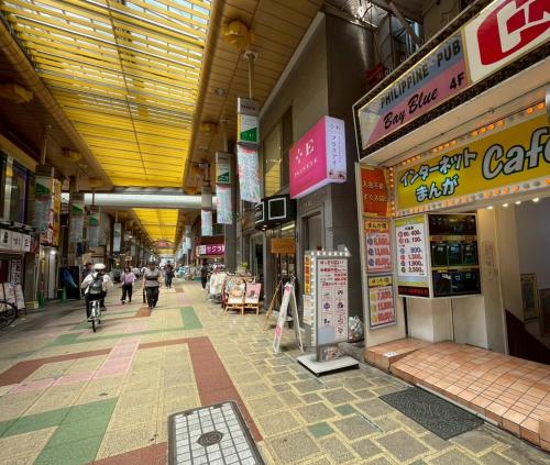 a shopping mall with people walking around and shops at New! Stay in Kamata West Exit Gourmet Street! in Tokyo