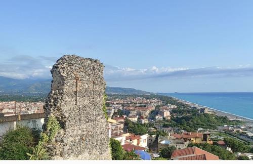 a tall stone tower on top of a city at Villa Aurea Rooms & More in Papasidero