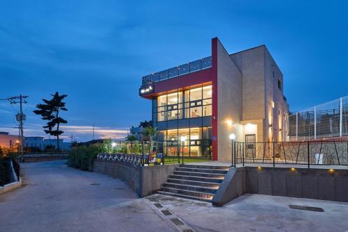 a large building with stairs in front of it at Daebudo DuMong DalGeum Pool Villa in Ansan